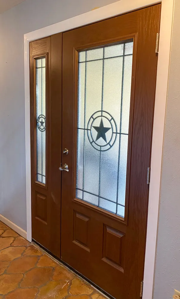 New wood-look entry door with a tall glass panel