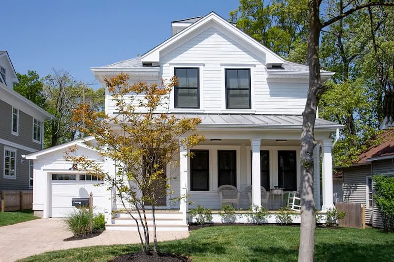 White two-story home with new windows and a front porch