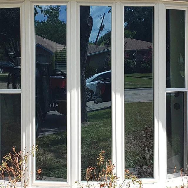 Close view of a bow window with tall white-framed panes