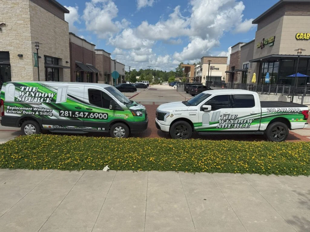 A Window Source of Houston van and pickup truck in green and white company wrap, parked side by side