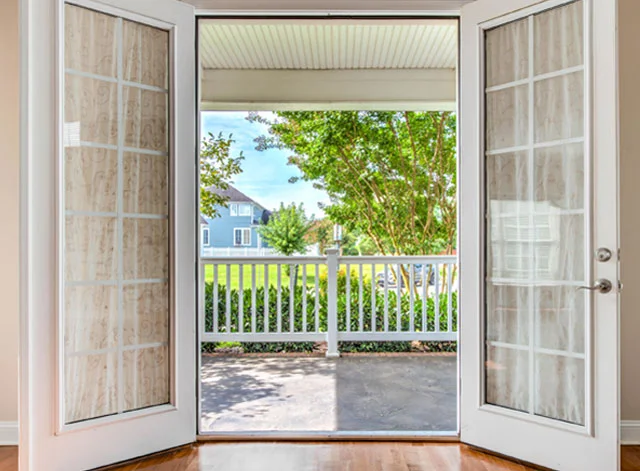 White French doors open onto a covered porch
