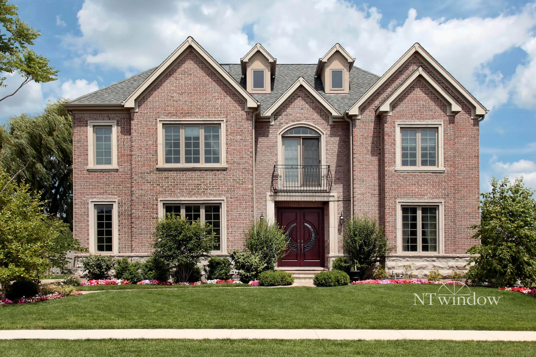 Two-story brick house with white windows