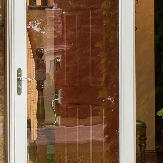 Glass storm door with a handle over a wood front door