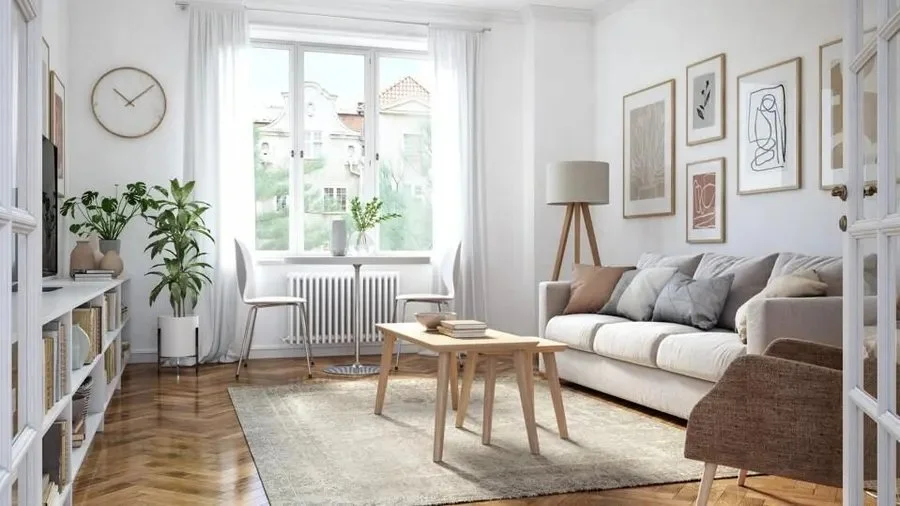 Bright living room with white-framed windows and a gray sofa