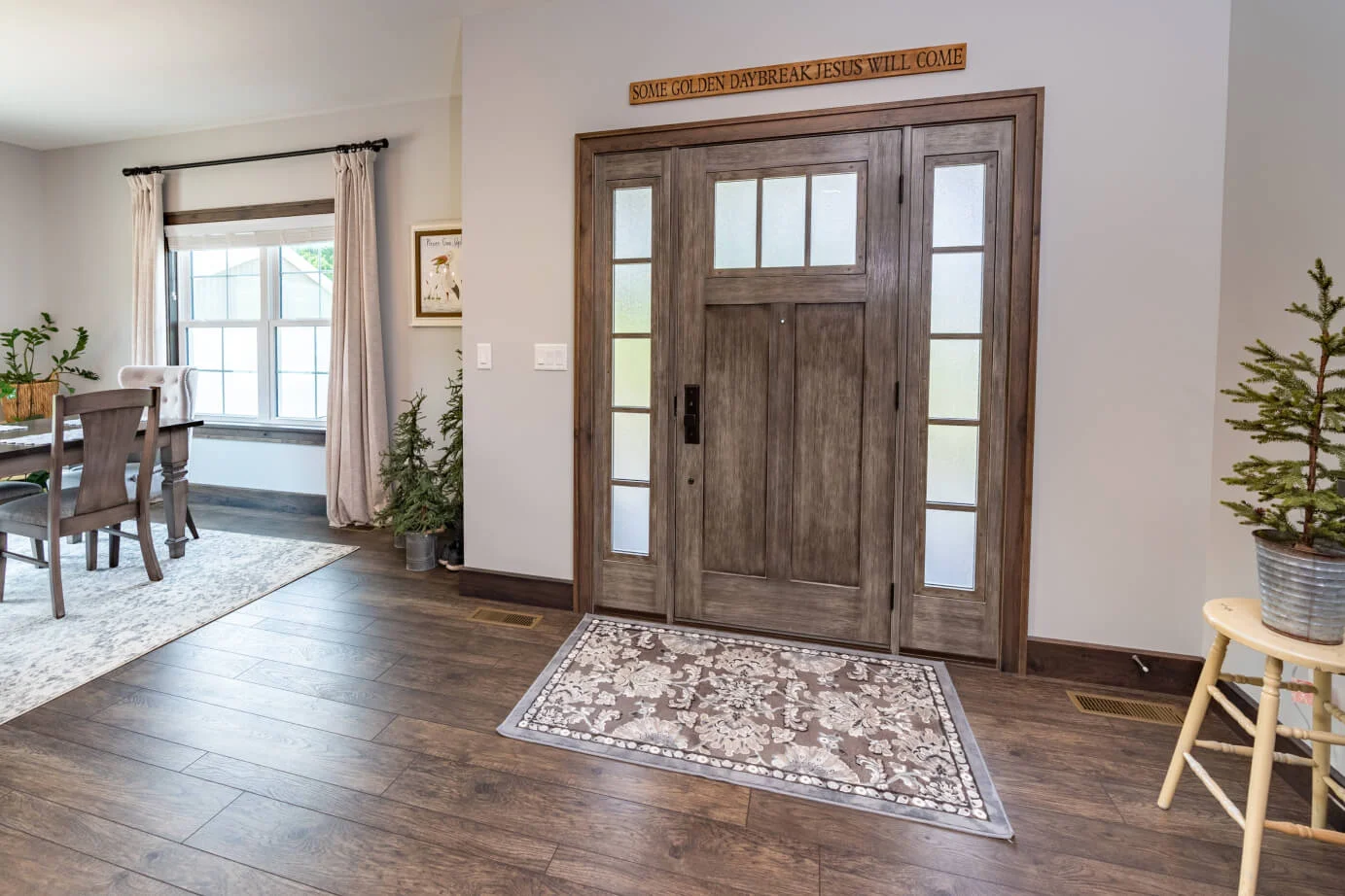Front entry with a wood-look door and glass sidelights, seen from inside