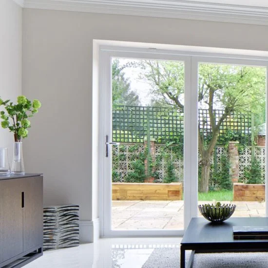 Sliding glass door in a bright living room, opening onto a garden