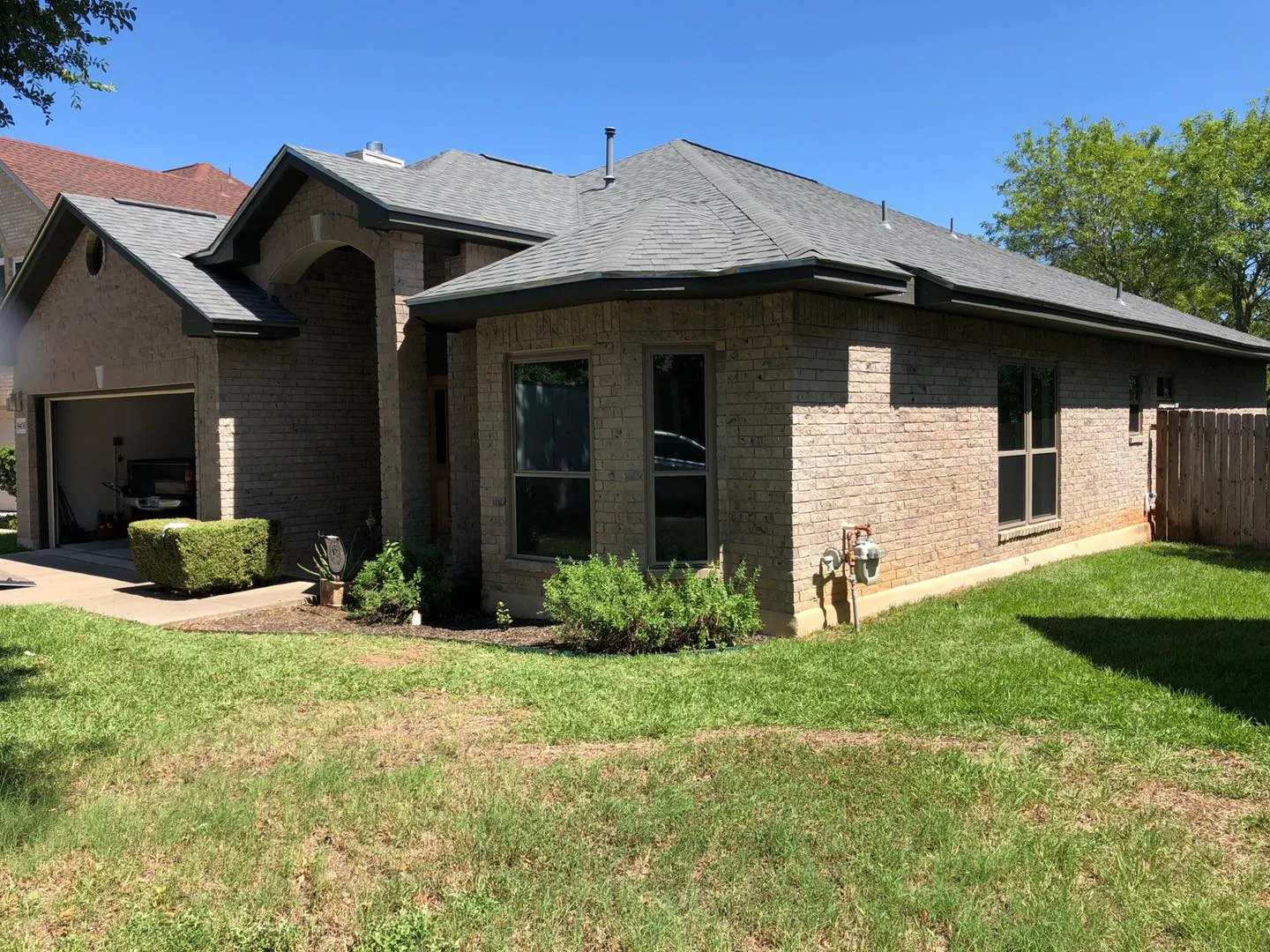 Brick home with new windows across the front and side